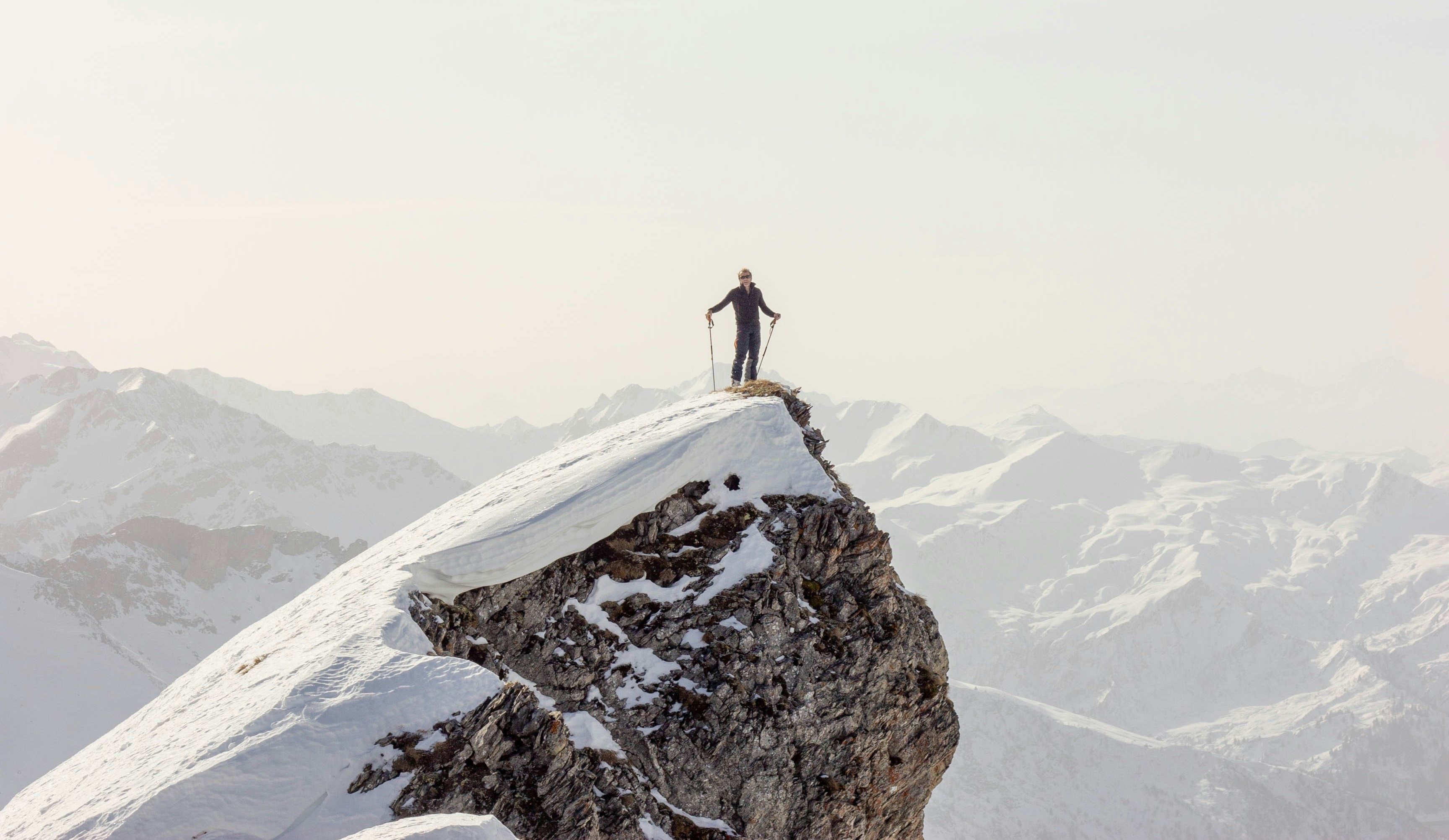 Skier making fresh powder turns on an off-piste alpine mountain slope in Chamonix